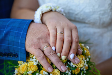 Beautiful flowers and wedding rings on the wedding day.