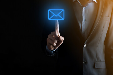 Businessman hand holding e-mail icon, Contact us by newsletter email and protect your personal information from spam mail. Customer service call center contact us concept