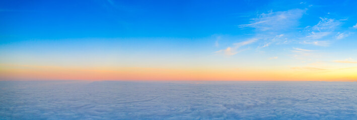 Fototapeta premium Dawn or sunset over the clouds, blue hour, aerial view.