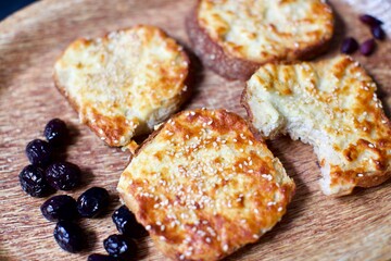 Toast with cheddar cheese and sesame seeds on a wooden tray. breakfast and snack