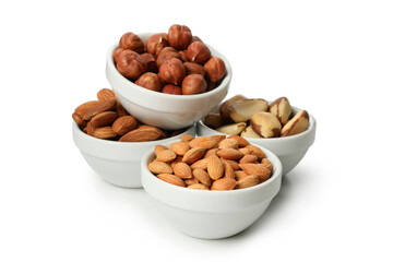 Bowls with different nuts isolated on white background