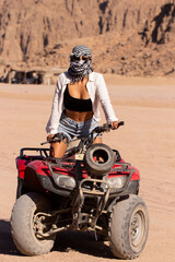 girl person riding atv in a desert