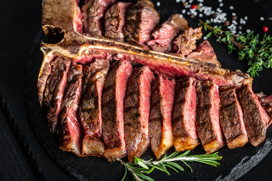 Barbecue dry aged Wagyu Porterhouse Steak. Beef T-Bone juicy steak Medium rare beef. American cuisine. Food recipe background. Close up