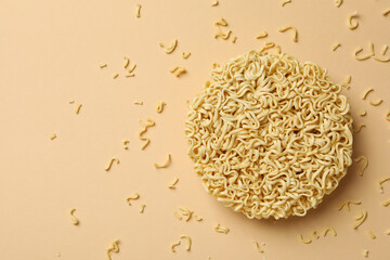 Circle of instant noodles on beige background