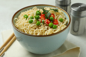 Concept of tasty eating with bowl of noodles on white textured background