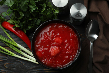 Concept of tasty food with borscht and ingredients on wooden background
