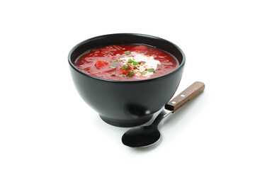 Bowl of beetroot soup and spoon isolated on white background