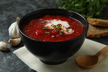 Concept of tasty eating with borscht on black smokey background