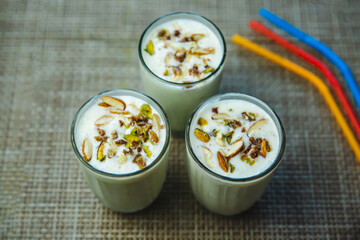 Homemade Banana Milkshake garnished with Nuts and Straws, Lassi