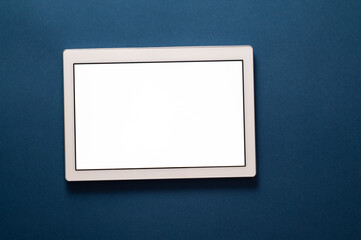 Tablet on a table with white copy space.