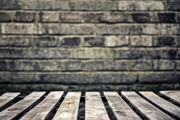 Wall background and an empty wooden table in the front. Blank space for a product placement.