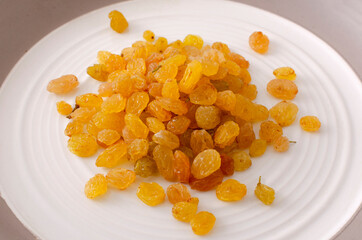Heap of sweet dried sultana grape on the white plate