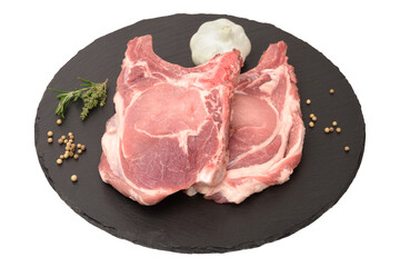 deux cotellets de porc cru échine  sur ardoise