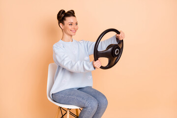 Profile photo of optimistic cool brunette lady sit drive wear sweater jeans isolated on pastel beige color background