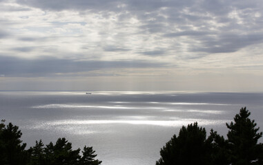 Sun shining through the clouds over the sea.
