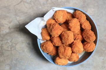 fried chicken pop nuggets in a cup.