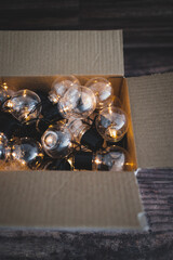 group of light bulbs shining from an open box, mindset and thinking outside the box