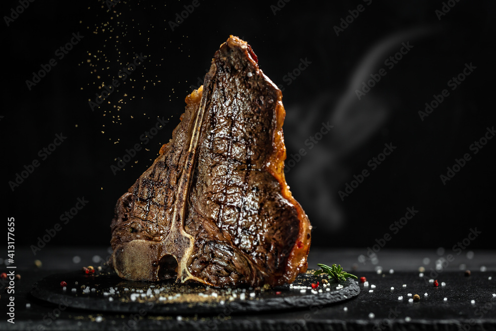 Wall mural aged barbecue porterhouse steak. beef t-bone juicy steak rare beef with spices. american cuisine. th