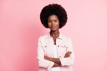 Portrait of pretty displeased skeptic wavy-haired girl top manager folded arms isolated on pink...
