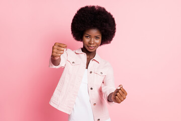 Portrait of nice pretty confident cheery girl driving invisible car practicing isolated over pink color background