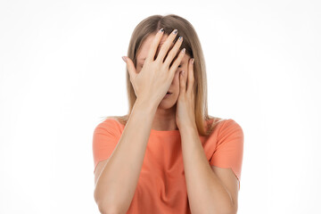 Portrait of scared blond girl hold hands near face trembling fear, very terrified. Human emotions concept