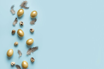 Easter greeting card with golden eggs on blue background with copy space. View from above. Flat lay.
