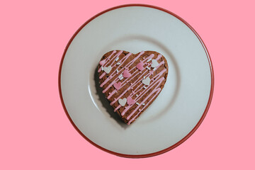 lovely heart shape sweet brownie cake on the pink background