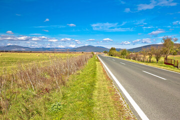 Krbava field. Scenic road through rural landscape of Lika region