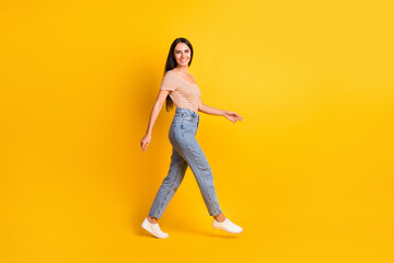 Full length body size side profile photo of pretty girl going hurrying up on meeting isolated on bright yellow color background