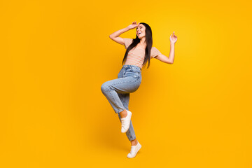 Fototapeta na wymiar Full length body size photo of female student relaxing at party dancing on floor smiling laughing isolated on bright yellow color background