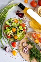 the process of making a salad of fresh vegetables and the meat of the finished salad in the frame. dressing vegetable salad with vegetable oil. mocap a bottle of vegetable oil.