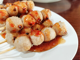 Meatballs on a white dish.