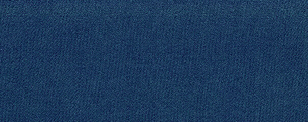 Federal Blue paper background. Narrow horizontal photo in denim color. Textured surface template...