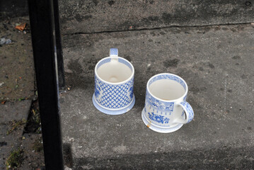 Two Blue and White Ceramic Mugs on Old Stone Steps