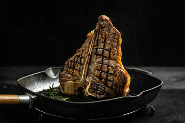 Gourmet t-bone steak cooked on grill in American meat restaurant. Dry Aged Barbecue Porterhouse...
