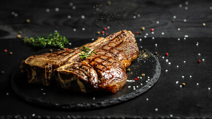 T-bone grilled beef steak. Dry Aged Barbecue Porterhouse Steak. Medium rare. American cuisine. Long...