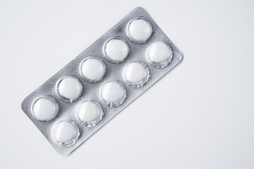 white pills in white background