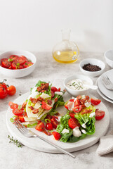 romaine lettuce topped with bacon tomato parmesan, sauce. healthy keto paleo diet lunch