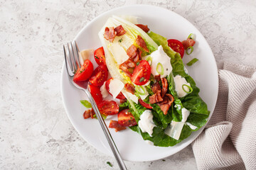 romaine lettuce topped with bacon tomato parmesan, sauce. healthy keto paleo diet lunch