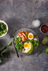 healthy keto paleo diet breakfast: boiled egg, avocado, halloumi cheese, salad leaves