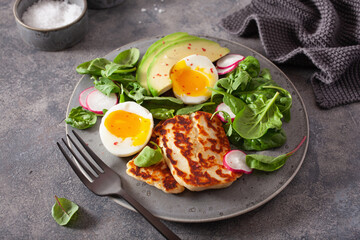healthy keto paleo diet breakfast: boiled egg, avocado, halloumi cheese, salad leaves