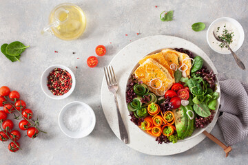 ketogenic paleo diet lunch bowl. halloumi cheese, avocado carrot cucumber salad leaves