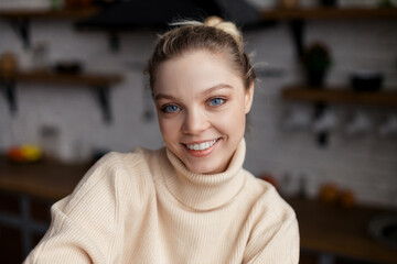 Happy young woman food blogger sit at home and record vlog teaching on webinar in app, webcam view