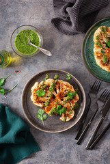 cauliflower steaks with herb sauce and spice. plant based meat substitute