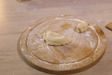 Girl makes dumplings with potatoes and mushrooms