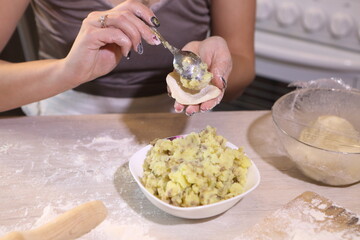 Girl makes dumplings with potatoes and mushrooms