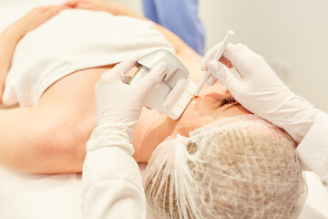 Woman having skin tightening with the ultrasound machine