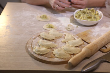 Girl makes dumplings with potatoes and mushrooms