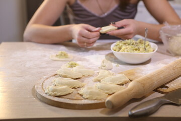 Girl makes dumplings with potatoes and mushrooms