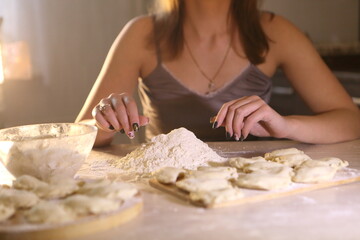 Girl makes dumplings with potatoes and mushrooms